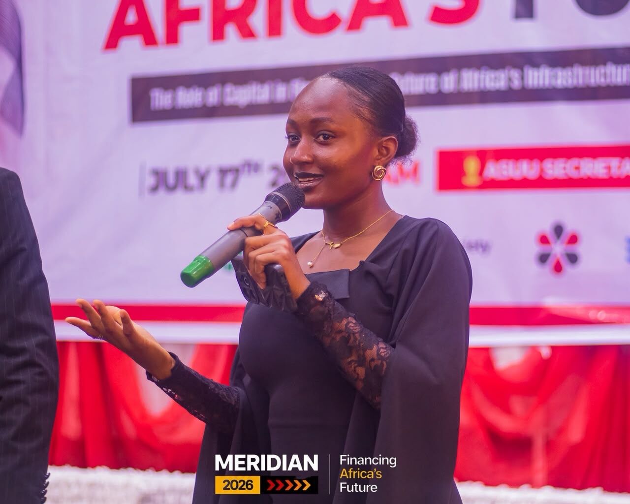 Maryjane Ejebughaobi speaking with a microphone at the Meridian 2026 conference